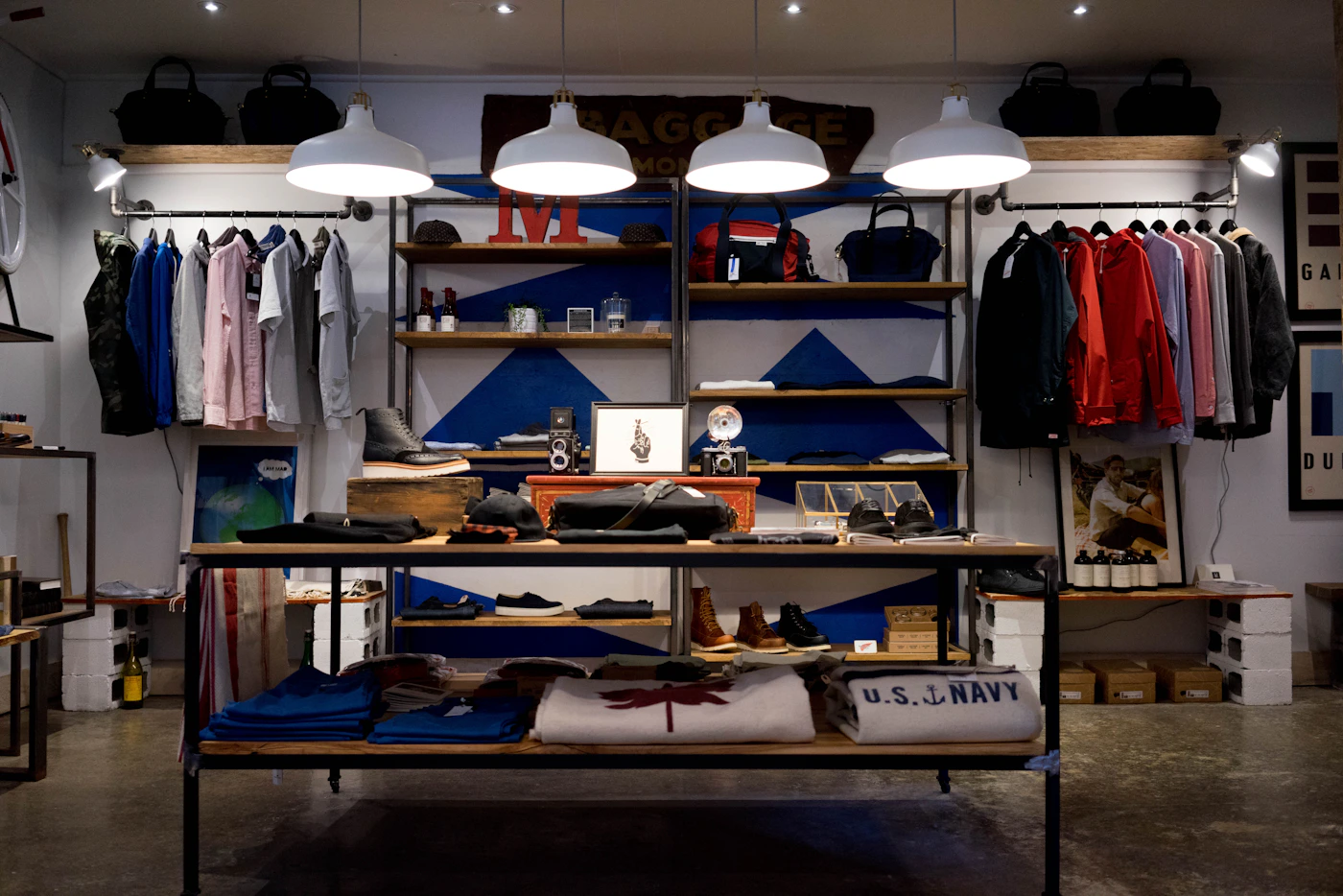 Clothing displays and wooden tables in a retail store